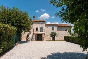 an old stone house with a driveway in front of it at Villa Treori in Orbani