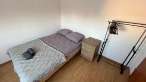 a bedroom with a bed and a night stand at ApartmentsByMatyrafa-IX in Tarnowskie Góry