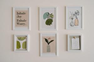 a group of framed pictures on a wall at Ca' Borsa II - Angolo nascosto nel cuore di Treviso in Treviso +7 photos
