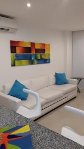 a living room with a couch and a painting on the wall at Morros Epic Cartagena in Cartagena de Indias