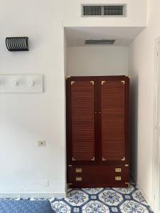 a bedroom with a wooden door in a room at Hotel America in Marina di Camerota
