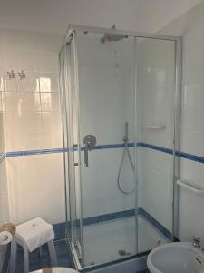 a bathroom with a shower and a sink at Hotel America in Marina di Camerota