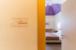 Postel nebo postele na pokoji v ubytování Le Magnolie Hotel