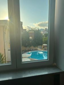 a window with a view of a swimming pool at Hotel America in Marina di Camerota