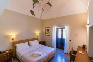 Postel nebo postele na pokoji v ubytování Le Magnolie Hotel