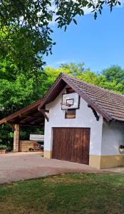 a building with a basketball hoop on top of it at Lassu Tanya Vendégház in Nagykőrös +55 photos