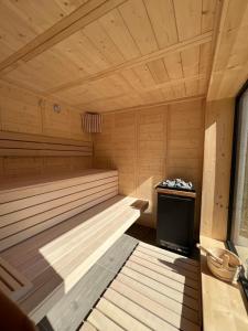 a large wooden sauna with a stove in it at Temple of the Sights in Buşteni +25 photos