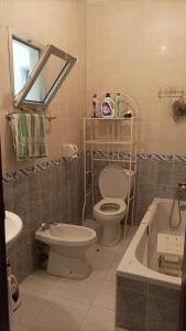 a bathroom with a toilet and a sink and a tub at Appart Tanger Family in Tangier +10 photos