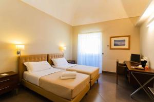 Postel nebo postele na pokoji v ubytování Le Magnolie Hotel