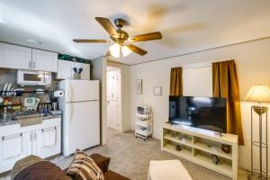 a living room with a refrigerator and a tv at Pecos Vacation Rental Near Rodeo Arena! in Pecos
