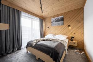 Posteľ alebo postele v izbe v ubytovaní Apartamenty Krupówki 20