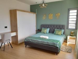 a bedroom with a bed and a desk in it at Villa Le Pendula in Grand Baie +23 photos