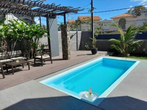 a swimming pool with a ball in the middle at Villa Le Pendula in Grand Baie