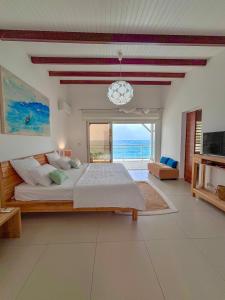 a bedroom with a large bed with a view of the ocean at Leynita Bay in Le Diamant +47 photos