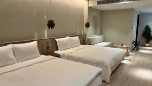 Postel nebo postele na pokoji v ubytování Hotel Initial-Tainan