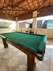 a pool table sitting inside of a room with at Elache Plaza Hotel in Roseira +11 photos