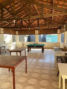 a large room with ping pong tables in it at Elache Plaza Hotel in Roseira