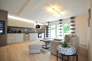 a living room with a couch and a table at Geschmackvolle moderne Apartment-Wohnungen in Hünfeld