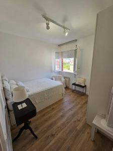a bedroom with a bed and a table with a lamp at Apartamento Bonavista in Vilassar de Mar +10 photos