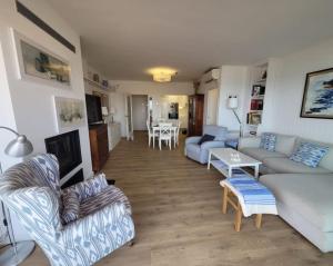 a living room with couches and a dining room at Apartamento Bonavista in Vilassar de Mar