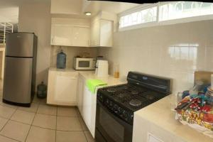 una cocina con estufa y refrigerador en La Casa del Risco, en Lázaro Cárdenas 11 fotos más