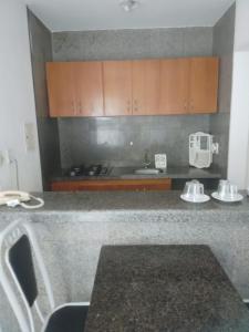 a kitchen with a granite counter top with a sink and a counter top at Via Venetto Flat in Fortaleza +41 photos
