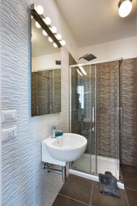 a bathroom with a sink and a shower at MARIMAR - Apartments OTRANTO in Otranto