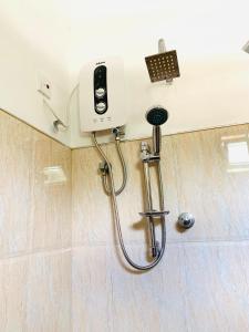 eine Dusche in einem Badezimmer mit einem Telefon an der Wand in der Unterkunft Modern Apartment near Galle Fort, Galle in Galle + 12 Fotos