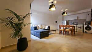 a living room with a blue couch and a dining room at Vi Hosting Anzoategui Aparts in Salta