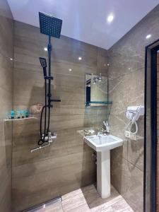 a bathroom with a sink and a shower at Villa Mzetamze in Borjomi +32 photos