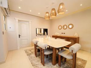 a dining room with a table and chairs at 3 BDR Serviced Pyramid-View APT in Giza, Egypt in Cairo