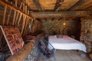 a bedroom with a bed and a cat sitting in a basket at Borda Jarca, casa rústica en plena naturaleza - HUT 8142 in Prats