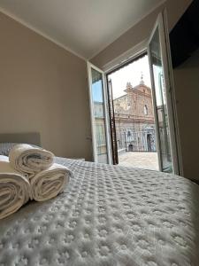 a bedroom with a bed and a large window at Bed and Breakfast Il Cacciatore in Mormanno +6 photos