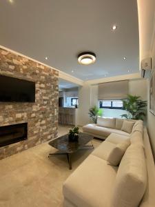 a living room with a couch and a fireplace at Stone Crafted Luxury Villas in Nikiana