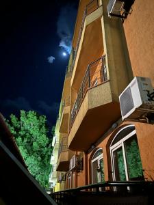 eine nächtliche Aussicht auf ein Gebäude mit einem Mond am Himmel in der Unterkunft Concordia Plaza 2 in Primorsko