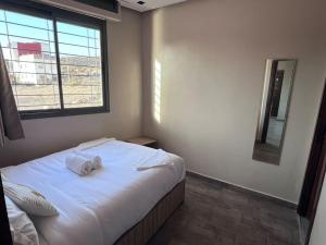 a bedroom with a bed with two towels on it at Appartement No 2 à Tamraght in Tamraght Ouzdar