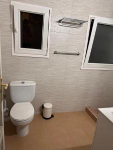a bathroom with a white toilet and a window at Villa IRI Habitación N 4 - Suit con balcón in Pineda de Mar +17 photos