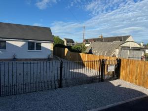 a black fence in front of a house at Hyde House in Ecclefechan