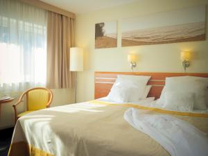 Łóżko lub łóżka w pokoju w obiekcie Hotel Nadmorski