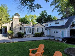 a house with two chairs in the yard at Luxury Historic North Hills Home in Knoxville