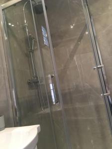 a shower with a glass door in a bathroom at ​Cœur de ville ! Cœur de l'Oise​​ ! Moderne & fonctionnel​ in Clermont