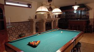 a pool table with balls on it in a room at Orion Guest Villa Casais in Lousada