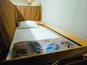 a small bed in a small room with at Historia Hostel in Skopje