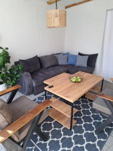 a living room with a couch and a table at Happy Vecation in Tuzla +5 photos