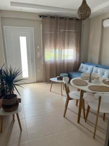 a living room with a table and a couch at Astron Apartments in Keramoti +9 photos