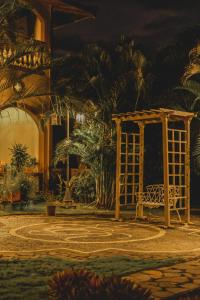a park with a bench and a gazebo at Hotel El Reith Lake in Granada +29 photos