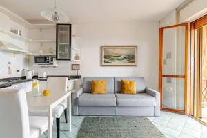 a living room with a couch and a table at TheKeyStudio, La Casa del Mare Azzurro with seaview in Ventimiglia
