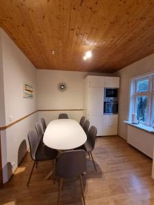 a dining room with a white table and chairs at Auðsholt 2 Old House 1930 in Fludir +45 photos