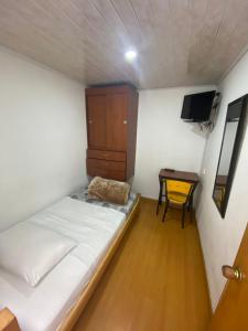 Postel nebo postele na pokoji v ubytování Hostal Casa Primavera