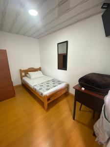 Postel nebo postele na pokoji v ubytování Hostal Casa Primavera